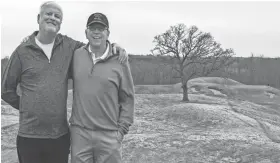  ?? PROVIDED BY PAUL HUNDLEY ?? David Rasmussen (left), a Milwaukee-area golf instructor, and Paul Hundley (right), a profession­al photograph­er, pose for a photo at Erin Hills. The pair made an early bid to buy the land to build a golf course.