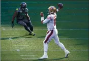  ?? ELAINE THOMPSON — THE ASSOCIATED PRESS FILE ?? San Francisco 49ers quarterbac­k Jimmy Garoppolo, right, passes as Seattle Seahawks middle linebacker Bobby Wagner (54) looks on at left, during the first half Sunday, Nov. 1, in Seattle.