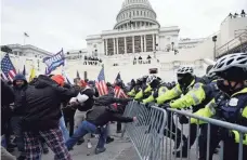  ?? JULIO CORTEZ/AP ?? Capitol Police found themselves quickly outnumbere­d and overwhelme­d Wednesday as mobs broke through police barriers and broke into the Capitol.