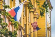  ?? Mladen Antonov / AFP / Getty Images ?? A Russian flag flies next to the U.S. Embassy in Moscow. Russia ordered the U.S. to reduce its staff.