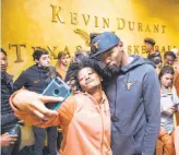  ??  ?? University of Texas women’s basketball player Jordan Hosey poses for a selfie with Durant as the school’s practice facility.