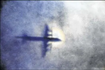  ?? ROB GRIFFITH / ASSOCIATED PRESS 2014 ?? The shadow of a Royal New Zealand Air Force P3 Orion is seen on low-level cloud while the aircraft searches for missing Malaysia Airlines Flight MH370 in the southern Indian Ocean, near the coast of Western Australia, in 2014.