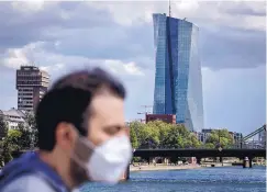  ?? MICHAEL PROBST/ASSOCIATED PRESS ?? A man walks in front of the European Central Bank Wednesday in Frankfurt, Germany. The European economy shrank by 3.8% in the first quarter, the most since records began, as business activity was frozen by shutdowns aimed at preventing the spread of the coronaviru­s. It was the biggest drop since statistics started in 1995.