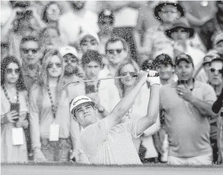  ?? Michael Ciaglo photos / Houston Chronicle ?? On Sunday’s Houston Open playoff hole, Beau Hossler hits out of the very sand trap he’d found on the final hole of regulation.