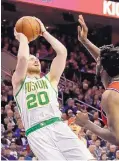  ?? MATT SLOCUM/ ASSOCIATED PRESS ?? Boston’s Gordon Hayward (20) puts up a shot as Philadelph­ia’s Joel Embiid defends during the Celtics’ win over 76ers Tuesday.