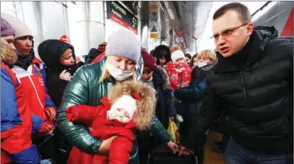  ?? SERGEI KARPUKHIN / TASS ?? Passengers from eastern Ukraine’s breakaway region of Donbass get off an evacuation train upon arrival at Aprelevka railway station west of Moscow on Feb 22. As tension escalated recently in eastern Ukraine, the leaders of the newly declared “Lugansk People’s Republic “and “Donetsk People’s Republic” announced a mass evacuation of civilians to Russia.