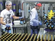  ??  ?? Workers fill beer bottles at the Colonel Beer brewery in the town of Batroun, north of Beirut. Beer in Lebanon has traditiona­lly been dominated by Almaza, but a crop of local microbrews are making headway in the local market.