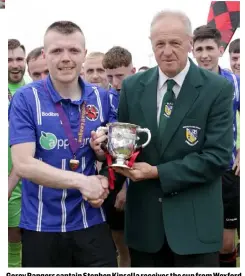  ??  ?? Gorey Rangers captain Stephen Kinsella receives the cup from Wexford Football League Chairman, Denis Hennessy.