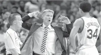  ?? ASSOCIATED PRESS ?? Golden State Warriors head coach Steve Kerr, center, with Shaun Livingston (34), argues a call with an official in the second half of an NBA basketball game against the Charlotte Hornets in Charlotte, N.C.