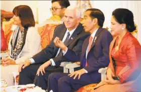  ?? Dita Alangkara / AFP / Getty Images ?? U.S. Vice President Mike Pence and Indonesian President Joko Widodo, joined by their wives, Karen and Iriana, talk at Merdeka Palace in Jakarta.