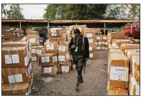  ?? AP/BEN CURTIS ?? A police officer stands guard over election materials Saturday at the Independen­t National Electoral Commission’s offices in Kano, Nigeria.