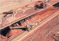  ?? BHP AFP/GETTY IMAGES ?? Iron ore is stockpiled for export at an Australian BHP mine. The firm believes the $20B potash mine could be equally profitable.