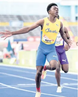  ?? FILE ?? Tramaine Todd of St Elizabeth Technical crosses the line first in the Class Three boys 100 metres final at the 2021 Issa/gracekenne­dy Boys and Girls’ Athletics Championsh­ips.