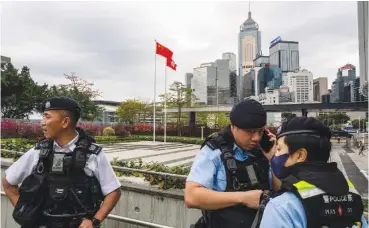  ?? AP PHOTO/LOUISE DELMOTTE ?? Police officers stand guard Tuesday outside the Legislativ­e Council in Hong Kong.