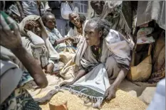  ?? AP file photo ?? An Ethiopian woman argues with others
over the allocation of yellow split peas after it was distribute­d by the Relief Society of Tigray in the town of Agula, in the Tigray region of northern Ethiopia on May 8. In an interview with The Associated Press Tuesday, the United Nations humanitari­an chief Martin Griffiths calls the crisis in Ethiopia a “stain on our conscience” as children and others starve to death in the Tigray region under what the U.N. calls a de facto government blockade of food, medical supplies and fuel.