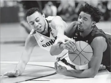  ?? Tony Avelar Associated Press ?? XAVIER GUARD Quentin Goodin, right, grabs a loose ball next to Gonzaga guard Nigel Williams-Goss during the West Regional final. Gonzaga defeated Xavier, 83-59, to advance to the Final Four.