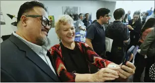  ?? ?? Pomona College Community Center Director Sefa Aina, left, takes a selfie with Anne Thorward of Newcomers Access Center during the opening ceremony of Pomona College Community Center in Pomona on Saturday.