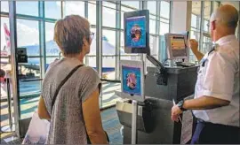  ?? Jim Watson AFP/Getty Images ?? A WOMAN goes through the facial recognitio­n verificati­on system VeriScan at Dulles Internatio­nal Airport in Virginia this month.