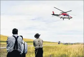  ?? Thom Bridge Associated Press ?? THE AIR-AMBULANCE industry says reimbursem­ents don’t cover expenses. Above, a helicopter f lies over the scene of a fatal collision in Montana in 2015.