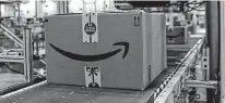  ?? REUTERS ?? Packaged merchandis­e on a conveyer belt after being labeled for shipping is seen at the Amazon fulfillmen­t center in New Jersey. Online retailers are expected to bring in record revenues on Monday.