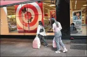  ?? SCOTT OLSON / GETTY IMAGES ?? Shoppers leave a Target store last month in Chicago. Target’s overall sales growth rose to a 13-year high in the most recent quarter.