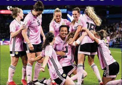  ??  ?? IN THE PINK: Scotland’s women’s team celebrate a goal against Argentina at the World Cup in France in June