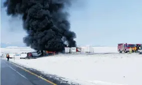  ?? WYOMING HIGHWAY PATROL/The Associated Press ?? Smoke rises from the site of a fiery crash on Interstate 80 near Laramie, Wyo. Monday. The
highway was shrouded in dense fog when the chain-reaction crash happened.