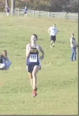  ?? Photo by Angela Wood ?? Julia Wood is all smiles as she heads for the finish at last month's districts meet in Rappahanno­ck.