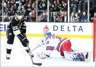  ??  ?? Trevor Lewis #22 of the Los Angeles Kings misses a chance to score on Henrik Lundqvist #30 of the New YorkRanger­s during the second period at Staples Center on Jan 21, in Los Angeles, California. (AFP)