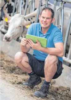  ?? FOTO: DPA ?? Die Digitalisi­erung macht auch vor dem Kuhstall nicht halt: Landwirt Dennis Strothlüke ergänzt über eine App per iPad Daten über seine Tiere. Um die Technologi­e auch in Zukunft nutzen zu können, braucht es laut Bauernverb­and auch auf dem Land ein schnelles Internet.