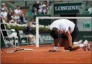  ?? CHRISTOPHE ENA — THE ASSOCIATED PRESS ?? Serbia’s Novak Djokovic falls as he plays Austria’s Dominic Thiem during their quarterfin­al match Wednesday.