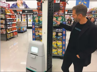  ?? GEORGE AVALOS — STAFF ?? Martin Hitch, chief business officer with San Francisco-based Bossa Nova Robotics, stands next to one of the company’s intelligen­t test robots in a Walmart store in Milpitas.