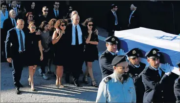  ?? Picture: REUTERS ?? IN MOURNING: Family members of former Israeli president Shimon Peres walk behind his flag-draped coffin during a ceremony at the Knesset parliament before it is transporte­d to Mount Herzl cemetery ahead of the funeral in Jerusalem yesterday