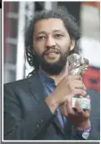  ?? — AFP ?? FrenchSene­galese director Alain Gomis poses with the Silver Bear award for the film Félicité.