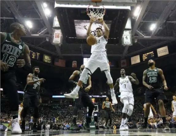  ?? MORRY GASH — THE ASSOCIATED PRESS ?? Bucks’ Giannis Antetokoun­mpo dunks during the first half of Game 4 against the Celtics.