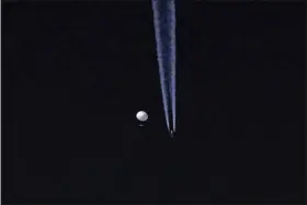  ?? BRIAN BRANCH VIA AP ?? A large balloon drifts above the Kingston, N.C. area, with an airplane and its contrail seen below it. The United States says it is a Chinese spy balloon moving east over America at an altitude of about 60,000feet, but China insists the balloon is just an errant civilian airship used mainly for meteorolog­ical research that went off course due to winds and has only limited “self-steering” capabiliti­es.