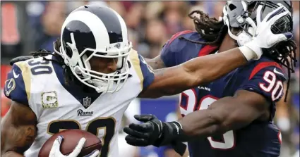  ??  ?? In this Nov. 12, 2017, file photo, Los Angeles Rams running back Todd Gurley pushes away Houston Texans outside linebacker Jadeveon Clowney during the first half of an NFL football game, in Los Angeles. AP PHOTO/ALEX GALLARDO