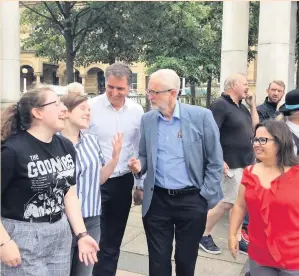  ??  ?? Southport students Rosie Morgan, left, and Isobel Mills meet Jeremy Corbyn, Steve Rotheram, and Liz Savage in town on Tuesday