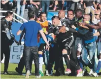  ??  ?? Restrained...Lyon goalkeeper Anthony Lopes is held back by Bastia security staff