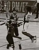  ?? AP ?? The Clippers’ Lou Williams (23) passes the ball over the Nuggets’ Jamal Murray (27) and Jerami Grant (9) on Monday in Lake Buena Vista, Fla.