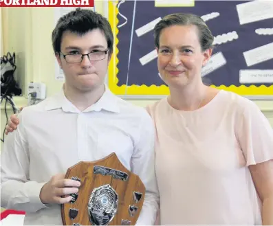  ??  ?? Prize guy Pupil of the year Clark Morgan with principal teacher Louise Wishart