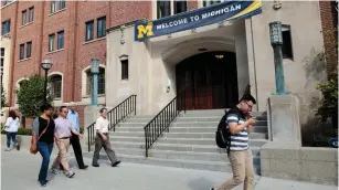  ?? (Rebecca Cook/Reuters) ?? A WELCOME BANNER is seen on a University of Michigan building in Ann Arbor.