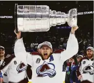  ?? Bruce Bennett / Getty Images ?? The Avalanche’s Nathan MacKinnon lifts the Stanley Cup after defeating the Lightning 2-1 in Game 6 on Sunday in Tampa, Fla.