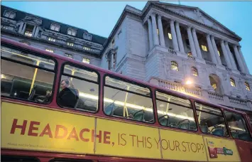  ?? PHOTO: BLOOMBERG ?? An advertisem­ent offering pain relief for headaches on the side of a bus passing in front of the Bank of England in London. The UK economy’s better-than-expected performanc­e since the Brexit vote is helping to lift consumers’ confidence, though they...
