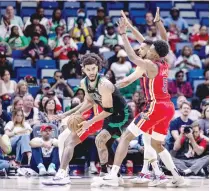  ?? — USA TODAY Sports ?? Jayson Tatum (0) is defended by Naji Marshall (8), Jones (5), and CJ Mccollum (3).