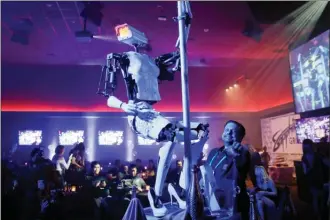  ?? The Associated Press ?? A pole-dancing robot built by British artist Giles Walker performs at a gentlemen’s club in Las Vegas. Monday’s event was held to coincide with CES Internatio­nal.