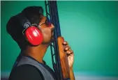  ?? AFP, AP ?? Ankur Mittal ( left) en route to his men’s double trap bronze at the Belmont Shooting Complex. Om Mitharval poses with his bronze in the men’s 50m pistol event. —