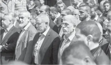  ??  ?? Yahya Sinwar (centre right), the new leader of Hamas in the Gaza Strip and senior political leaders of the Islamist movement, Ismail Haniyeh (centre left) and Rawhi Moshtaha (second left) attend the funeral of Mazen Faqha in Gaza city. — AFP photo