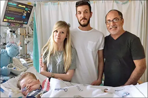  ??  ?? Hope: Connie Yates and Chris Gard with Charlie and Rev Patrick Mahoney, right, who posted the picture on Facebook