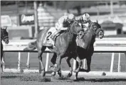  ?? Associated Press ?? NEWGATE, left, with Frankie Dettori aboard, holds on to win the Robert B. Lewis Stakes at Santa Anita.